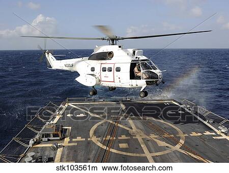 Helicopter lands aboard the Arleigh Burke-class guided-missile destroyer USS Farragut. View Large Photo Image Picture - Helicopter lands aboard the Arleigh Burke-class guided-missile destroyer USS Farragut.. Fotosearch
