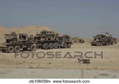 HEMTT trucks carry combat modified versions of M998 humvees. View Large Photo Image Picture - HEMTT trucks carry combat modified versions of M998 humvees.. Fotosearch