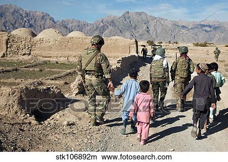 hildren walk alongside coalition force members in Afghanistan. View Large Photo Image Picture - hildren walk alongside coalition force members in Afghanistan.. Fotosearch