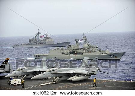 HMAS Ballarat of the Royal Australian Navy cruises alongside US Navy ships. View Large Photo Image Picture - HMAS Ballarat of the Royal Australian Navy cruises alongside US Navy ships.. Fotosearch