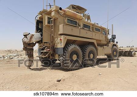 Hospital Corpsman loads up a Mine Resistant Ambush Protected vehicle. View Large Photo Image Picture - Hospital Corpsman loads up a Mine Resistant Ambush Protected vehicle.. Fotosearch