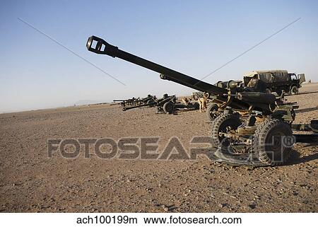 Howitzer 105mm light guns are lined up at Camp Bastion, Afghanistan. View Large Photo Image Picture - Howitzer 105mm light guns are lined up at Camp Bastion, Afghanistan.. Fotosearch