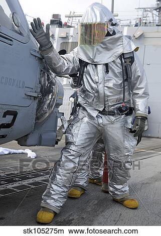 Picture - Hull Maintenance Technician checks an SH-60B Sea Hawk helicopter.. Fotosearch