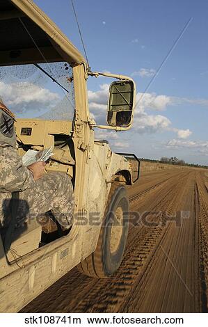 Humvee driving down a dirt road in Honduras. View Large Photo Image Picture - Humvee driving down a dirt road in Honduras.. Fotosearch