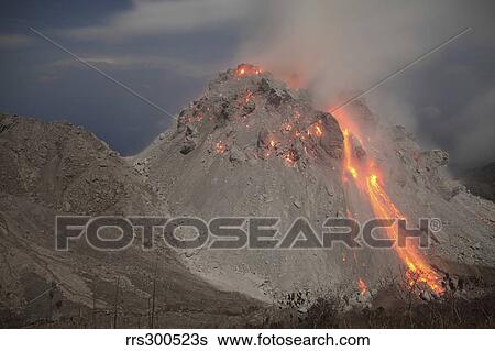 Stock Photograph - Incandescent rockfall at Rerombola lava dome of Paluweh volcano.. Fotosearch