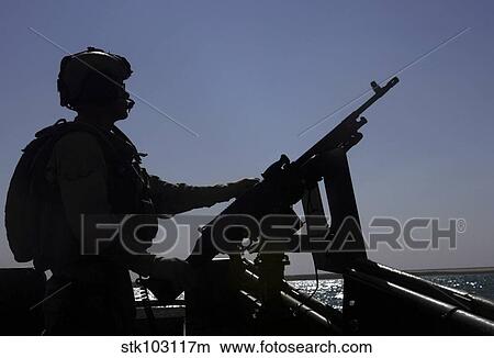 Information Systems Technician manning an M240 machine gun at Lake Quadsiyah near Haditha, Iraq. View Large Photo Image Picture - Information Systems Technician manning an M240 machine gun at Lake Quadsiyah near Haditha, Iraq.. Fotosearch