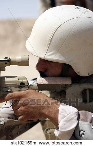 Iraqi Army Sergeant sights in down range during an advanced marksmanship course. View Large Photo Image Picture - Iraqi Army Sergeant sights in down range during an advanced marksmanship course.. Fotosearch
