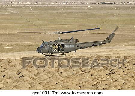 Picture - Italian Army AB-205MEP utility helicopter in flight over Shindand, Afghanistan.. Fotosearch
