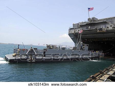 Landing Craft Utility moving into position near amphibious assault ship USS Essex in Subic Bay, Philippines. View Large Photo Image Picture - Landing Craft Utility moving into position near amphibious assault ship USS Essex in Subic Bay, Philippines.. Fotosearch