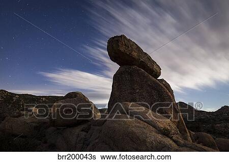Large boulders backdropped by stars and clouds, California. View Large Photo Image Stock Photograph - Large boulders backdropped by stars and clouds, California.. Fotosearch