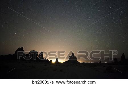 Stock Photograph - Large tufa formations at Trona Pinnacles against a backdrop of stars.. Fotosearch