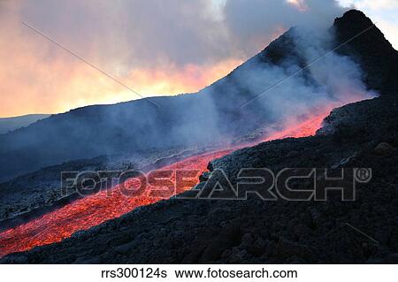 Lava flowing from base of hornito during eruption of Mount Etna volcano, Sicily, Italy. View Large Photo Image Stock Photograph - Lava flowing from base of hornito during eruption of Mount Etna volcano, Sicily, Italy.. Fotosearch