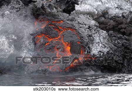 Stock Photograph - Lava flows from the Yemeni island of Jazirat at-Tair after the island erupted.. Fotosearch