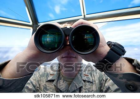 Lieutenant uses binoculars to scan the flightline at Holloman Air Force Base. View Large Photo Image Picture - Lieutenant uses binoculars to scan the flightline at Holloman Air Force Base.. Fotosearch