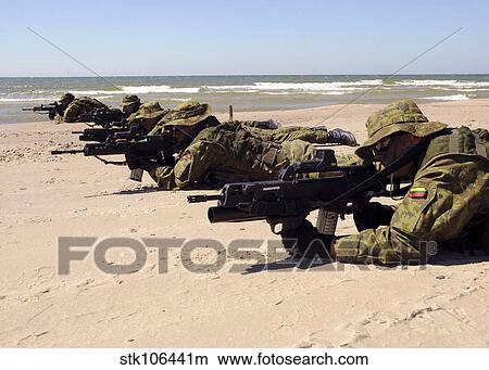 Lithuanian Special Forces members lie in formation on a beach. View Large Photo Image Picture - Lithuanian Special Forces members lie in formation on a beach.. Fotosearch