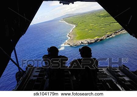 Loadmasters look out over Tumon Bay from a C-130 Hercules. View Large Photo Image Picture - Loadmasters look out over Tumon Bay from a C-130 Hercules.. Fotosearch