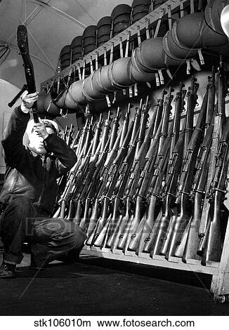 Looking over guns in guard room. View Large Photo Image Picture - Looking over guns in guard room.. Fotosearch