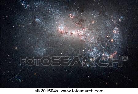 Stock Photograph - Magellanic dwarf irregular galaxy NGC 4449 in the constellation Canes Venatici.. Fotosearch