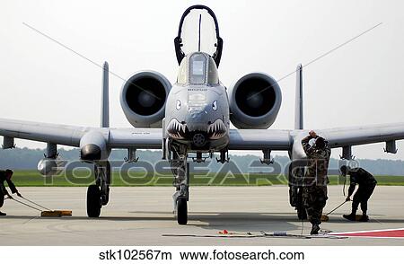 Maintainers place the chocks under an A-10C Thunderbolt II. View Large Photo Image Picture - Maintainers place the chocks under an A-10C Thunderbolt II.. Fotosearch