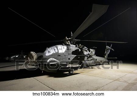 Maintenance crew work on an AH-64D Apache Longbow at night. View Large Photo Image Picture - Maintenance crew work on an AH-64D Apache Longbow at night.. Fotosearch