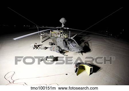 Maintenance crew works on servicing the OH-58 Kiowa before its next mission. View Large Photo Image Picture - Maintenance crew works on servicing the OH-58 Kiowa before its next mission.. Fotosearch
