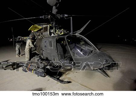 Maintenance crew works on servicing the OH-58 Kiowa before its next mission. View Large Photo Image Picture - Maintenance crew works on servicing the OH-58 Kiowa before its next mission.. Fotosearch