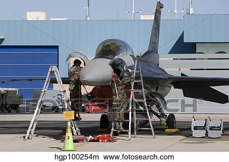 Maintenance personel work on an F-16 Fighting Falcon. View Large Photo Image Picture - Maintenance personel work on an F-16 Fighting Falcon.. Fotosearch