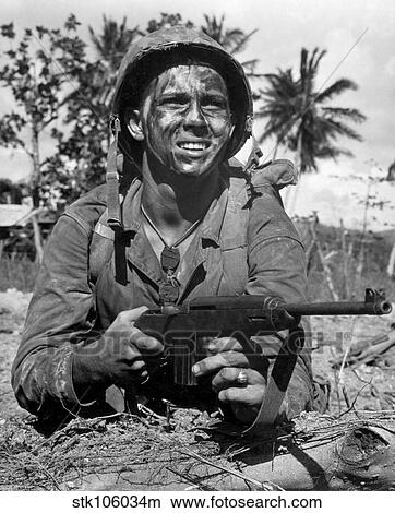 Picture - Marine awaits signal to go ahead in battle during World War II.. Fotosearch