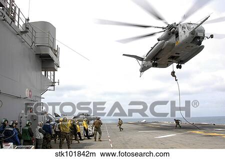 Marines and sailors fast-rope from a CH-53E Super Stallion. View Large Photo Image Picture - Marines and sailors fast-rope from a CH-53E Super Stallion.. Fotosearch
