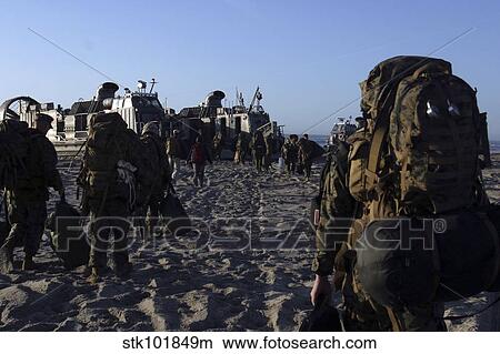Picture - Marines and Sailors load onto a Landing Craft Air-Cushion hovercraft.. Fotosearch