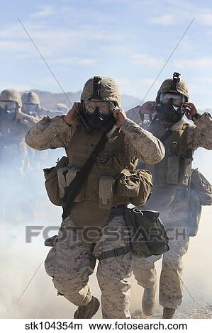 Marines and sailors participate in an outdoor gas exercise in full protective gear. View Large Photo Image Picture - Marines and sailors participate in an outdoor gas exercise in full protective gear.. Fotosearch