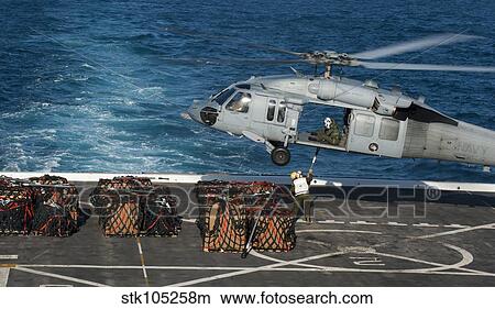 Marines attach cargo to an MH-60S Sea Hawk helicopter. View Large Photo Image Picture - Marines attach cargo to an MH-60S Sea Hawk helicopter.. Fotosearch