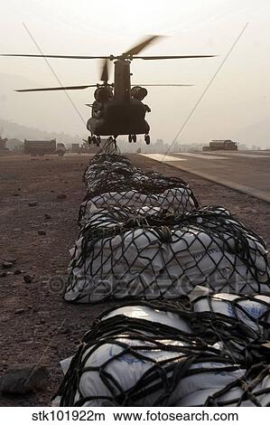 Marines attach sling loads to the body of an Army CH-47 Chinook cargo helicopter. View Large Photo Image Picture - Marines attach sling loads to the body of an Army CH-47 Chinook cargo helicopter.. Fotosearch