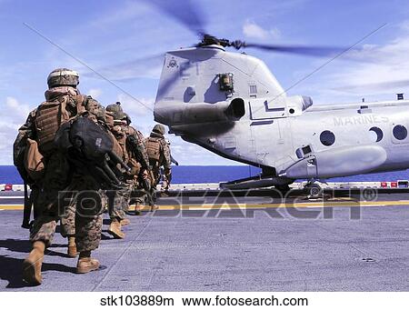 Marines board a CH-46E Sea Knight helicopter aboard USS Essex. View Large Photo Image Picture - Marines board a CH-46E Sea Knight helicopter aboard USS Essex.. Fotosearch