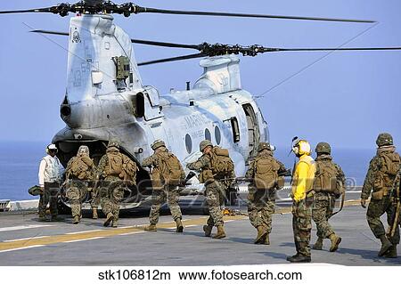 Marines board a CH-46E Sea Knight helicopter. View Large Photo Image Picture - Marines board a CH-46E Sea Knight helicopter.. Fotosearch