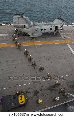 Marines embark a CH-46E Sea Stallion helicopter aboard USS Makin Island. View Large Photo Image Picture - Marines embark a CH-46E Sea Stallion helicopter aboard USS Makin Island.. Fotosearch