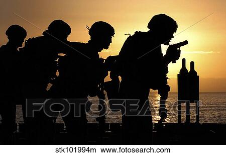 Marines fire 9mm handguns on the flight deck of USS Peleliu. View Large Photo Image Picture - Marines fire 9mm handguns on the flight deck of USS Peleliu.. Fotosearch