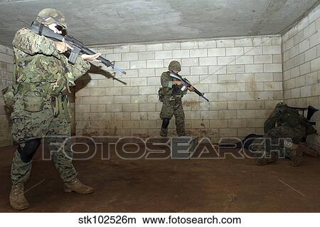 Picture - Marines hold an SASO instructor down while checking him to see if he has any hidden weapons.. Fotosearch