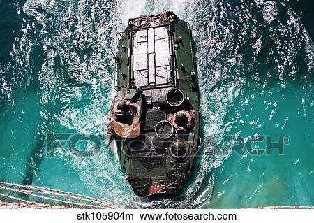 Marines maneuver an amphibious assault vehicle into a well deck. View Large Photo Image Picture - Marines maneuver an amphibious assault vehicle into a well deck.. Fotosearch