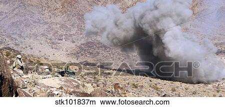 Picture - Marines perched atop Machine Gun Hill watch down range as explosives detonate.. Fotosearch