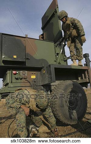 Picture - Marines prepare the antenna of an AN/TPQ-46A radar system.. Fotosearch