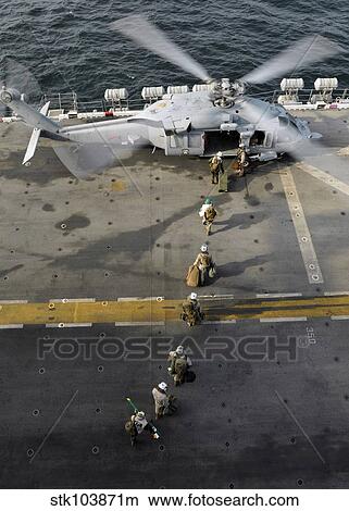 Marines prepare to board an MH-60S Sea Hawk helicopter aboard USS Peleliu. View Large Photo Image Picture - Marines prepare to board an MH-60S Sea Hawk helicopter aboard USS Peleliu.. Fotosearch