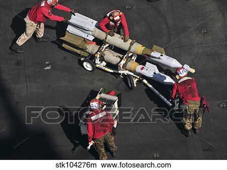 Marines push pordnance into place on the flight deck of USS Enterprise. View Large Photo Image Picture - Marines push pordnance into place on the flight deck of USS Enterprise.. Fotosearch