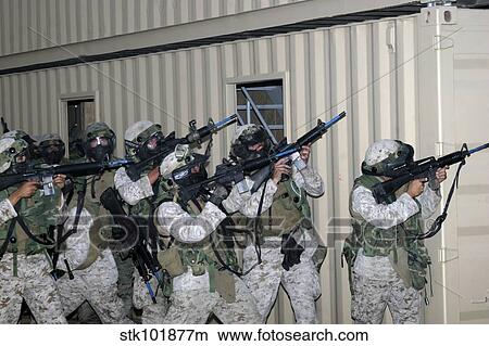 Marines raise their weapons toward targeted threats. View Large Photo Image Picture - Marines raise their weapons toward targeted threats.. Fotosearch