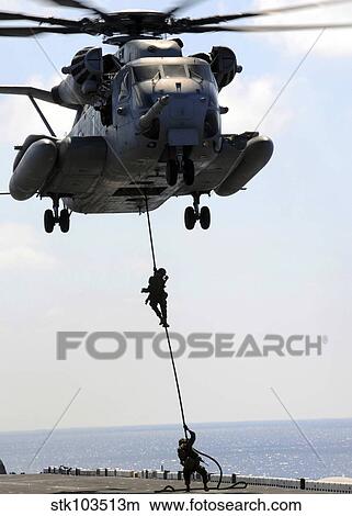 Marines rappel from a CH-53E Sea Stallion helicopter. View Large Photo Image Picture - Marines rappel from a CH-53E Sea Stallion helicopter.. Fotosearch