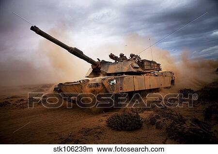 Marines roll down a dirt road on their M1A1 Abrams Main Battle Tank. View Large Photo Image Picture - Marines roll down a dirt road on their M1A1 Abrams Main Battle Tank.. Fotosearch