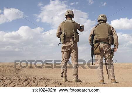 Marines scan the horizon for insurgent activity during a security patrol. View Large Photo Image Picture - Marines scan the horizon for insurgent activity during a security patrol.. Fotosearch