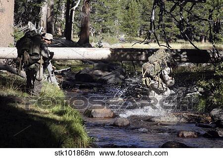Marines splash across a stream with a full combat load. View Large Photo Image Picture - Marines splash across a stream with a full combat load.. Fotosearch