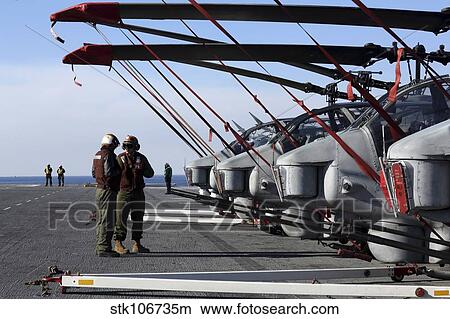 Marines stand next to a row of AH-1N Cobra helicopters. View Large Photo Image Picture - Marines stand next to a row of AH-1N Cobra helicopters.. Fotosearch