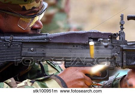 Picture - Master-at-Arms fires an M-60 machine gun.. Fotosearch